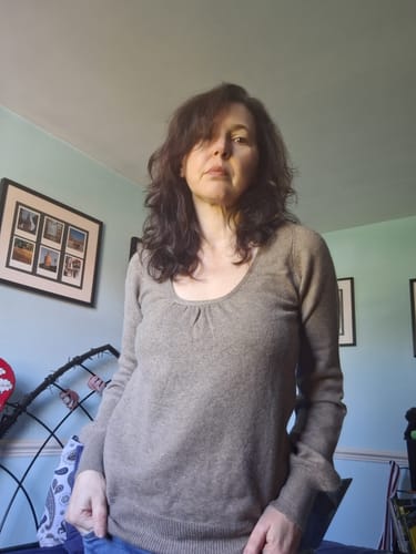 Customer's mocha brown cashmere scoop neck jumper worn by a person, showing the ruched neckline and balloon sleeves.