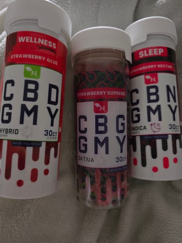 Customer's Strawberry Glue CBD Gummies container shown with two other wellness supplement bottles.