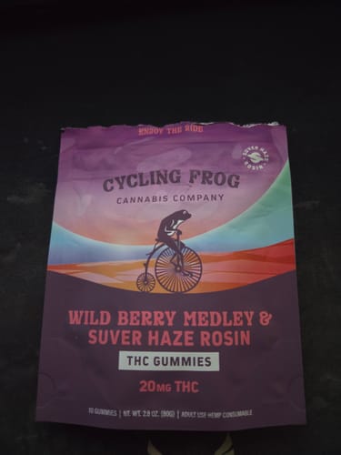 Customer's purple packaging for Wild Berry Medley Rosin Gummies featuring a frog on a bicycle illustration.