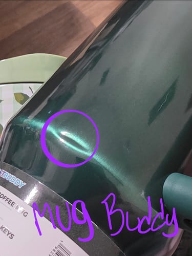 Customer's dark green Frost Buddy Mug Buddy with a small dent circled in purple marker.