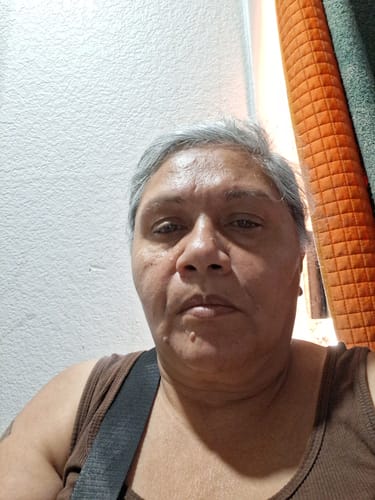 Reviewer in a brown tank top providing a positive review for the Pre Rolls 100ct.