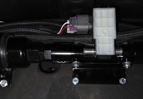 Customer's Billet E85 Flex Fuel Sensor Mount installed on a vehicle with black lines and an electrical sensor attached.