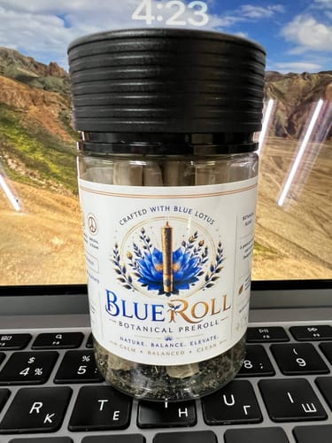 Customer's BlueRoll Blue Lotus and Hemp Pre-Rolls jar resting on a laptop keyboard.