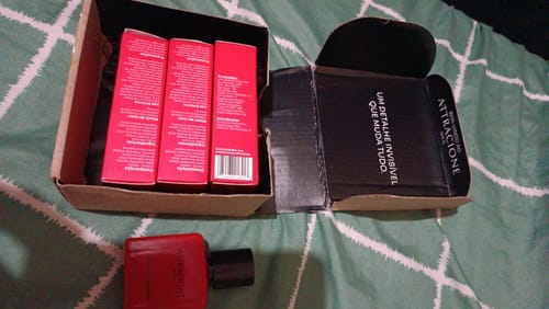 Customer's Attracione Men perfume box with three red containers and one red perfume bottle displayed.