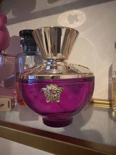 Customer's Versace Pour Femme Dylan Purple perfume bottle, in bright purple glass with a gold cap and Medusa logo.