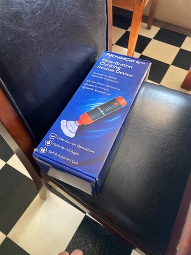 Customer's NovaCare One-Button Anti-Choking Device box resting on a chair