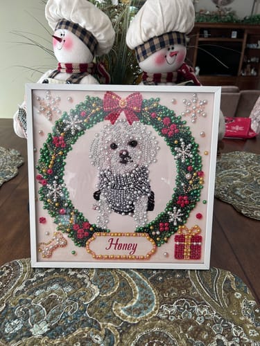 Customer's Personalized Christmas Pet Pearl Art showing a dog portrait inside a festive wreath, displayed on a table.