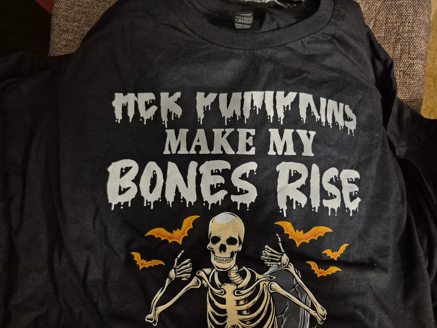 Customer photo review of Her Pumpkins Make My Bones Rise | Deluxe Unisex Tee v2
