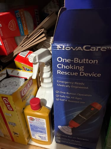 Customer's packaging for the NovaCare choking rescue device stored on a shelf with household items.