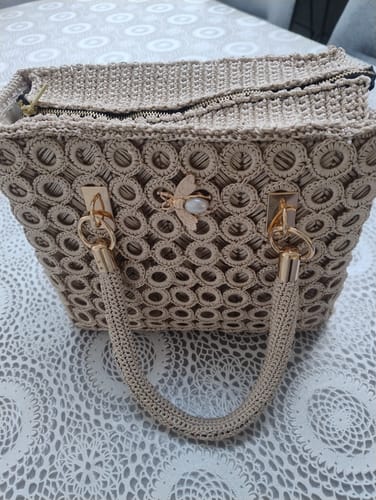 Customer's completed Garden Bee Crochet Bag with signature pearl bee charm, gold hardware, and beige crocheted texture.