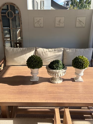 Customer's set of three Imogen metal wall art bird panels arranged on a wall above a dining table.