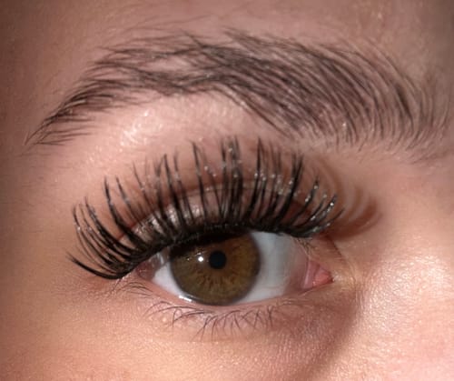 Reviewer's Auge mit applizierten, schwarzen The Heartbreaker Wimpernextensions in Nahaufnahme