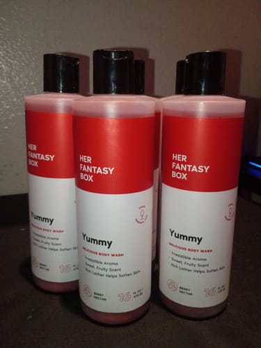 Customer's collection of Yummy Organic Body Wash bottles on a dark surface.
