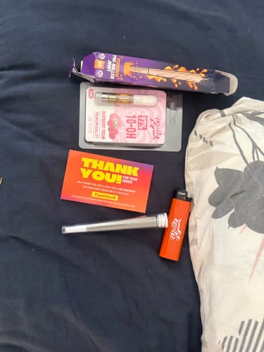 Customer's order including a THC-A Pre-Roll Cali Blend cone, a 10-OH cartridge, a promotional card, and an orange lighter.