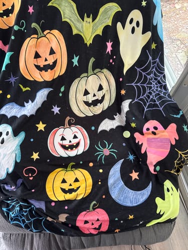 Customer's DIY Drawing Blanket colored with vibrant pumpkins, ghosts, and bats for a Halloween theme.
