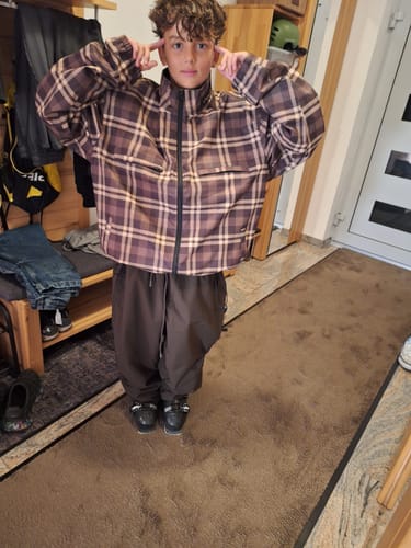 Customer's Men’s Coffee Baggy Drawstring Durable Snow Pants worn in a loose, baggy fit while standing indoors.