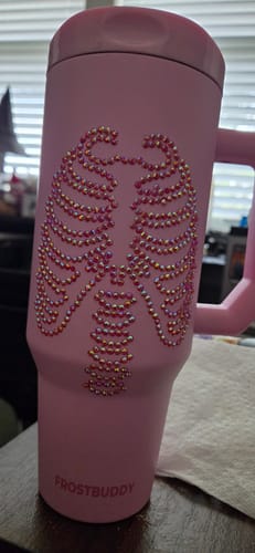 Customer's pink Thicc Buddy mug featuring a sparkling skeleton ribcage design and Frost Buddy branding.