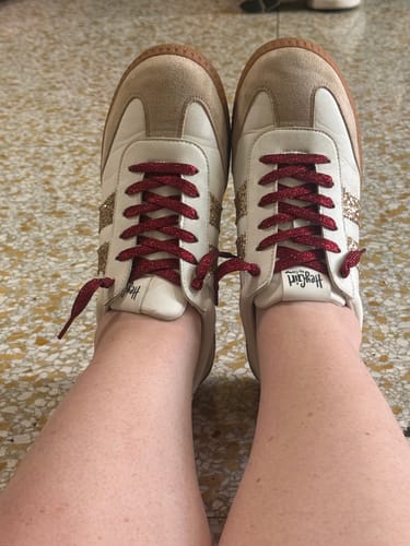 Reviewer's Heads Up Gold Glitter Sneakers on feet, updated with burgundy laces.