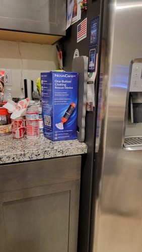 Customer's NovaCare One-Button Anti-Choking Device box sitting on a granite kitchen counter.