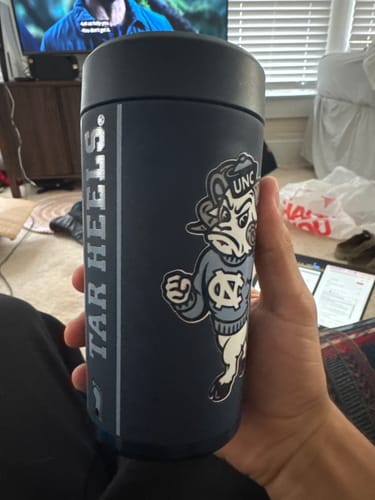 Customer's navy Universal Buddy cooler with UNC Tarheels mascot graphic being held in a hand.