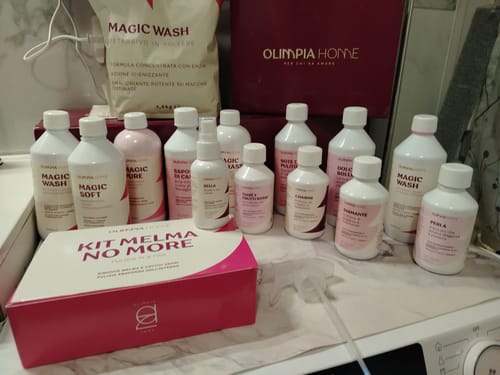 Customer's collection of Olimpia Home cleaning products, including bottles and a Kit Melma No More box on a surface.