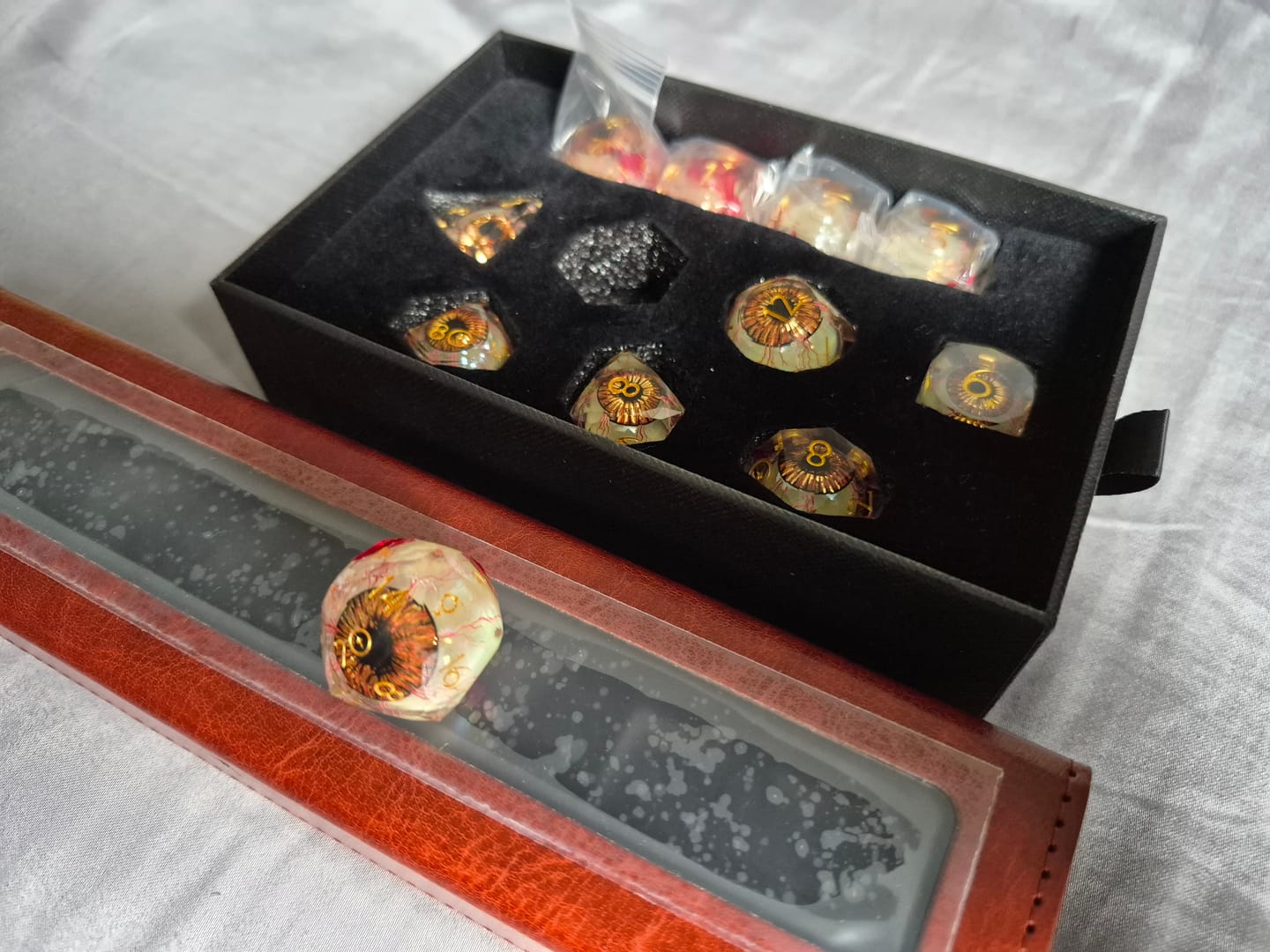 Customer photo review of URWizards D&D Eyes(Glow in the Dark) Liquid Core Dice Set Multi-faceted Style