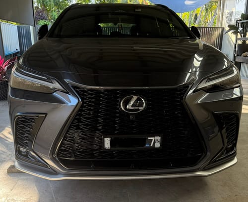 Reviewer's Lexus NX350H with installed Miniature Plinth holding a license plate on the front grille.