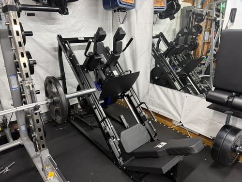 Reviewer's black RitFit Gazelle 3-in-1 machine set up in a home garage gym.