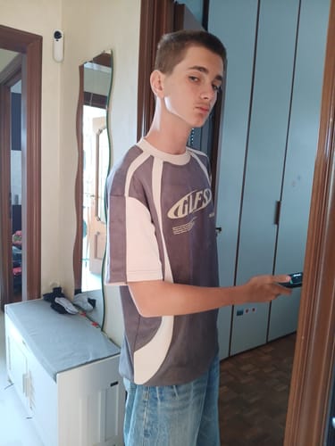 Customer's T-shirt GLFS with a charcoal grey and cream sports-style design, worn with jeans.