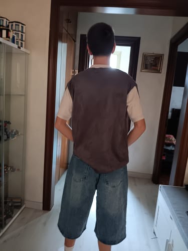 Customer's Jorts Washed in blue denim, showing a loose, baggy fit that falls below the knees.