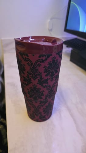 Customer's Velvet Grimoire To-Go Buddy tumbler with dark damask pattern on a desk near a computer monitor.