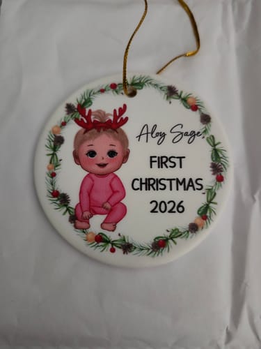 Customer's personalized Christmas ornament showing a baby cartoon illustration with the name Aloy Sage, 2026.