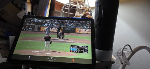 Customer's Bottle Buddy sitting next to a tablet playing a live baseball game.