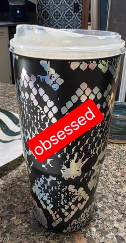 Customer's Moonlit Ink To-Go Buddy tumbler with a snake-skin pattern, featuring an obsessed sticker on the front.