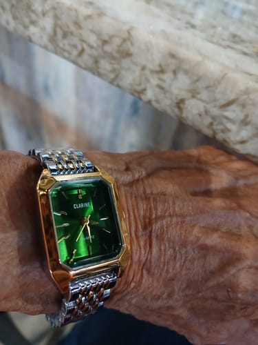 Customer's CLAIRE DE MAINS watch with a green rectangular face and two-tone metal band worn on a person's wrist.