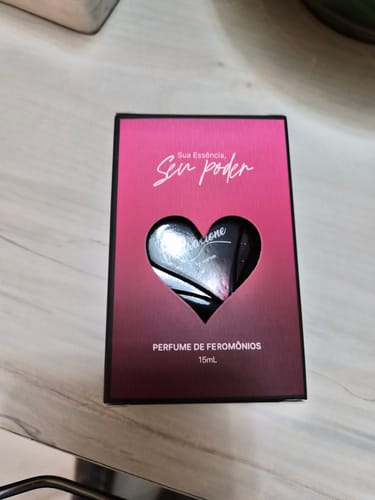 Customer's Attracione Sensual pheromone perfume packaging featuring a pink gradient box and a heart-shaped cutout.