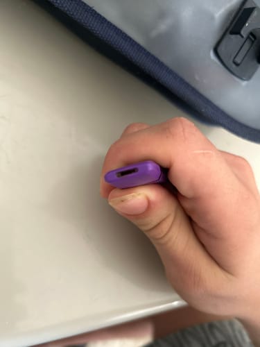 Customer's hand holding a purple 10-OH Vape device, showing a close-up of the mouthpiece area.