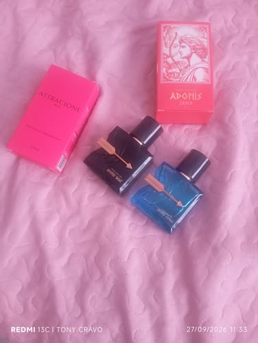 Customer's Kit Adonis + Attracione Men perfumes with two glass bottles and two product boxes on a pink surface.