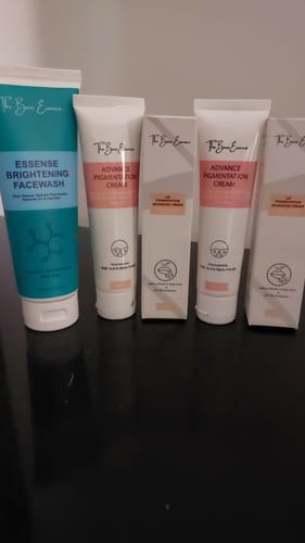 Customer's pack of Face Pigmentation Cream tubes and boxes lined up on a black surface.