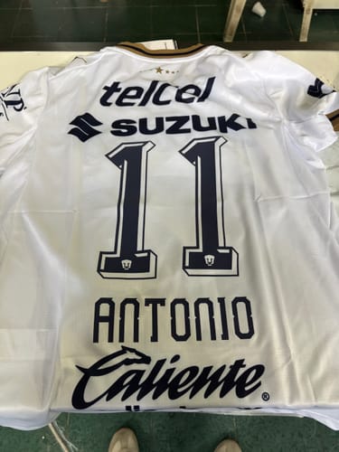 Customer's white Pumas UNAM Visita 26/27 jersey back view featuring number 11 and printed sponsor logos.