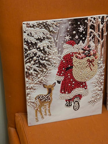 Reviewer's finished bead art kit featuring Santa Claus and a small deer in a snowy, festive landscape.