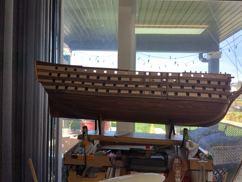 Customer's wooden Maqueta Barco Sec. Sma. Trinidad ship model kit in progress, sitting on a workbench.
