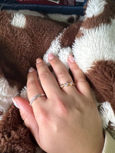 Customer's Orion's Light Ring worn on a finger, featuring a gold band with a clear square stone.