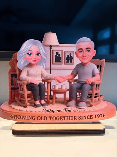 Customer's wooden plaque showing a couple in rocking chairs, personalized with Cathy, Tom, and the year 1976.