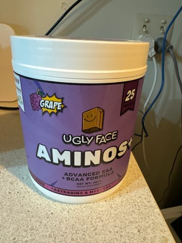 Reviewer's purple tub of UGLYFACE AMINOS+ sitting on a counter.