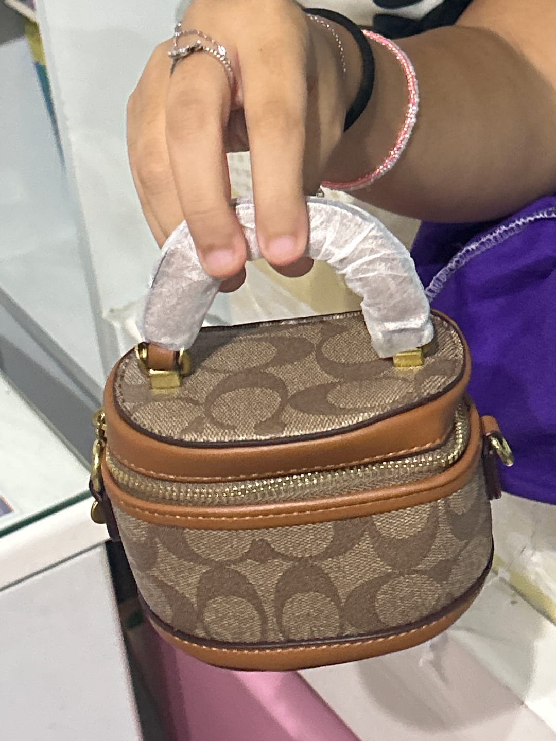 Customer photo review of Coach Trail Crossbody 12 in signature canvas, featuring a structured vanity-style silhouette accented with a gold-tone Coach "C" zipper pull