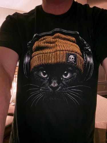 Customer's Bass Cat shirt featuring a black cat wearing a brown beanie with skull emblem and large headphones.