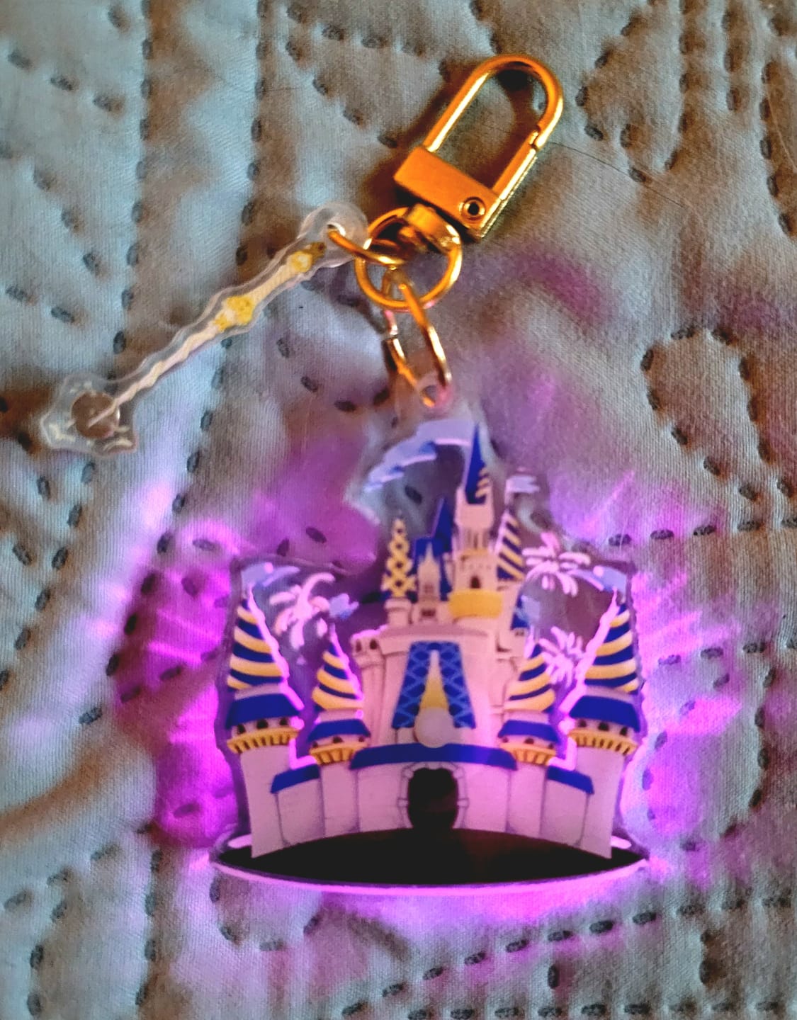 Customer photo review of Magic Kingdom Castle Light Up Interactive Keychain – Glows Pink When the Magic Turns On, Fireworks Included