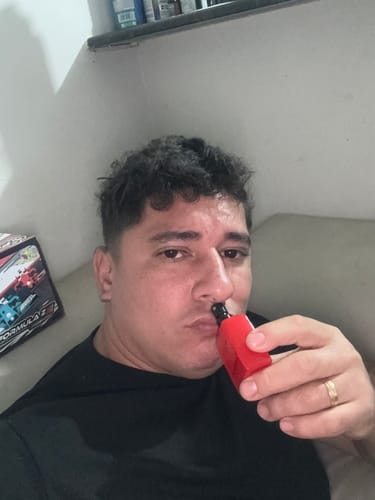 Customer's Attracione Men perfume with red bottle, being held and smelled by reviewer