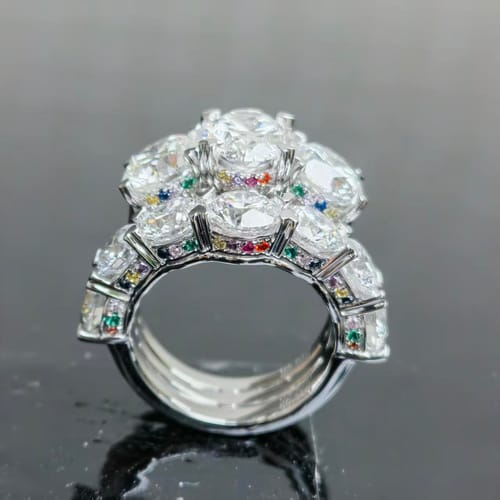Customer's wedding band set showing multiple diamond-encrusted rings with vibrant hidden halo stones.
